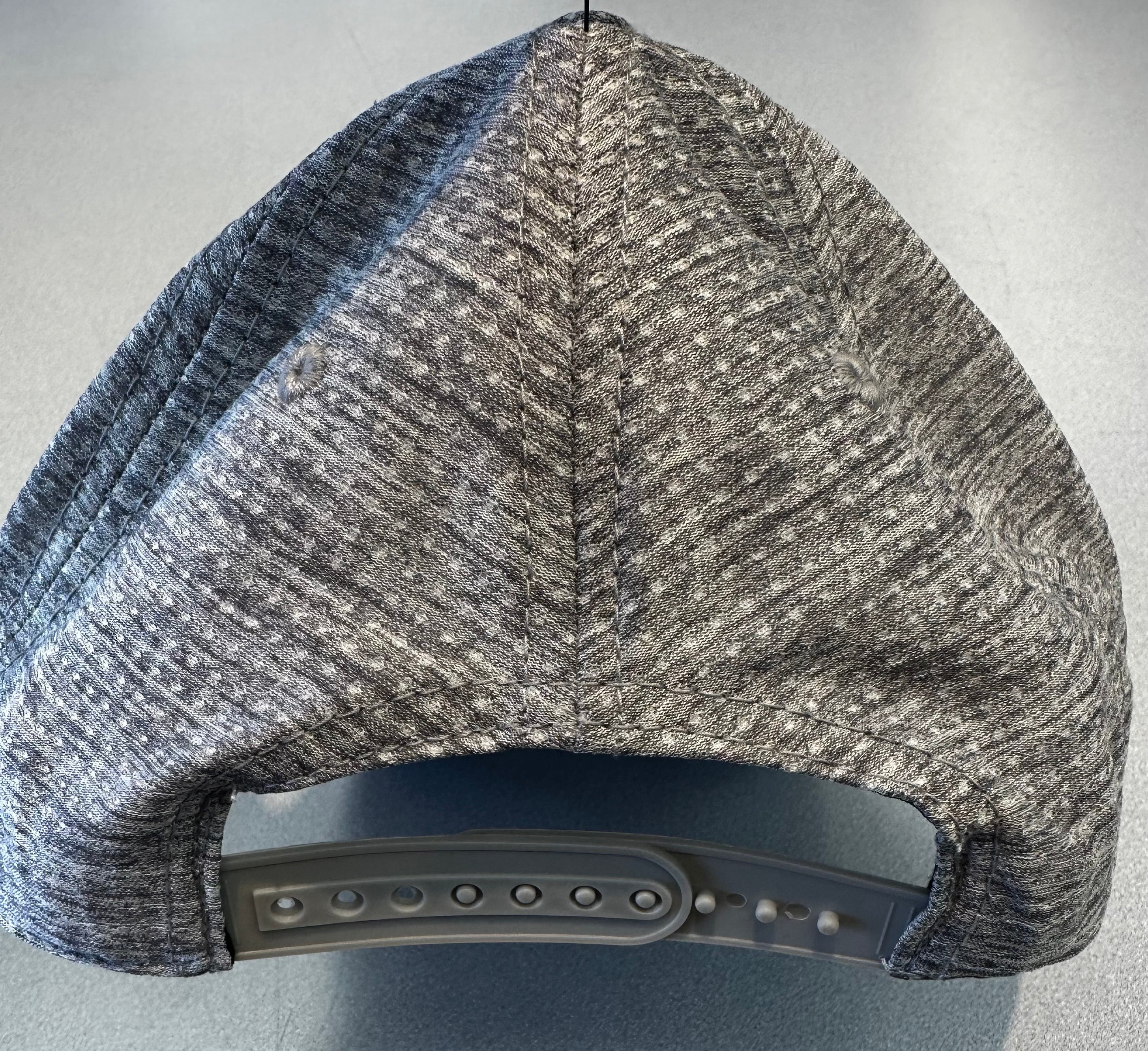 Gray and blue patterned cap on a gray background
