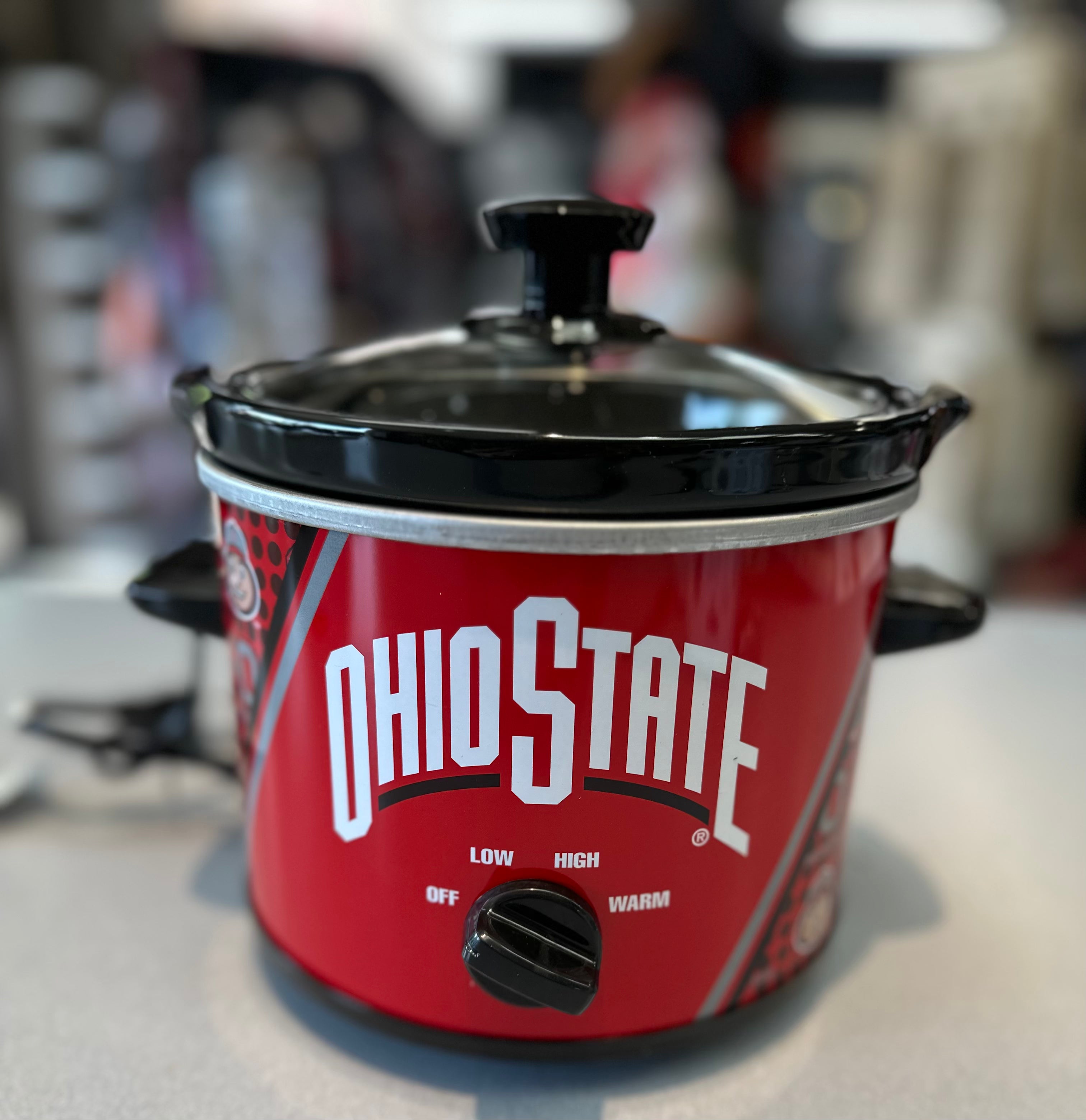Red slow cooker with 'Ohio State' branding on a blurred background