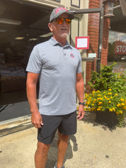 staffers wearing polo shirt outside of store