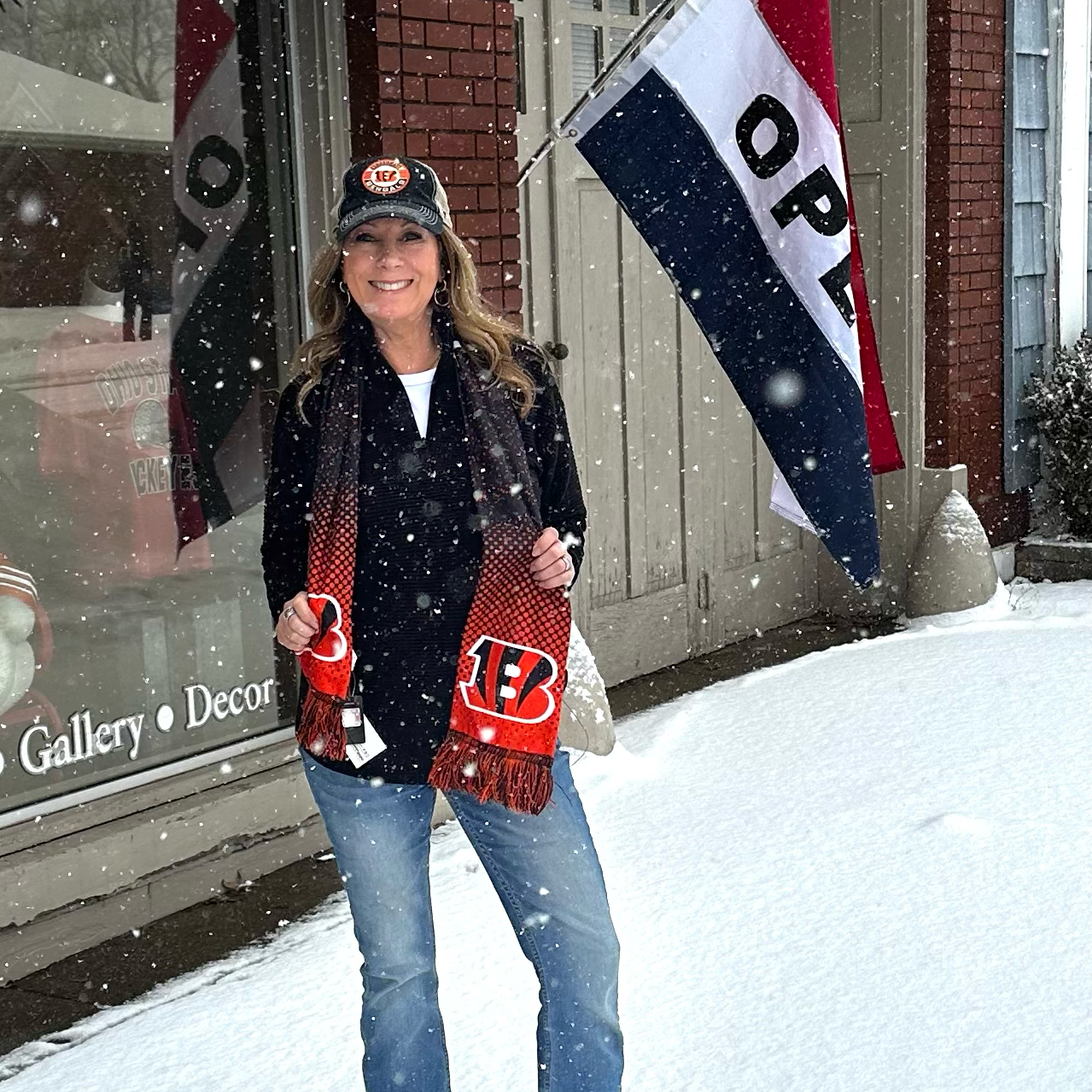 Woman holding sports team merchandise in front of a store with snow on the ground