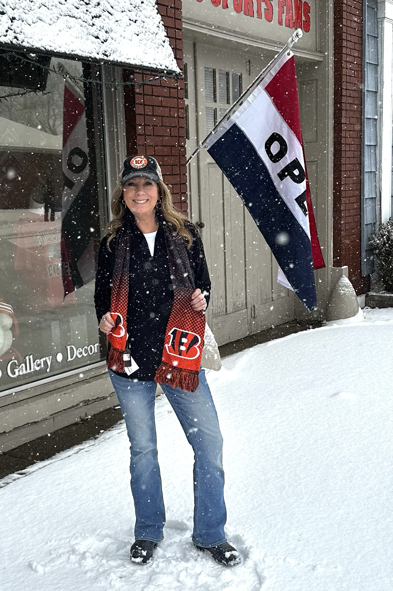 Woman holding sports team merchandise in front of a store with snow on the ground