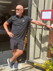 buckeye fan wearing black ohio state logo polo shirt at store
