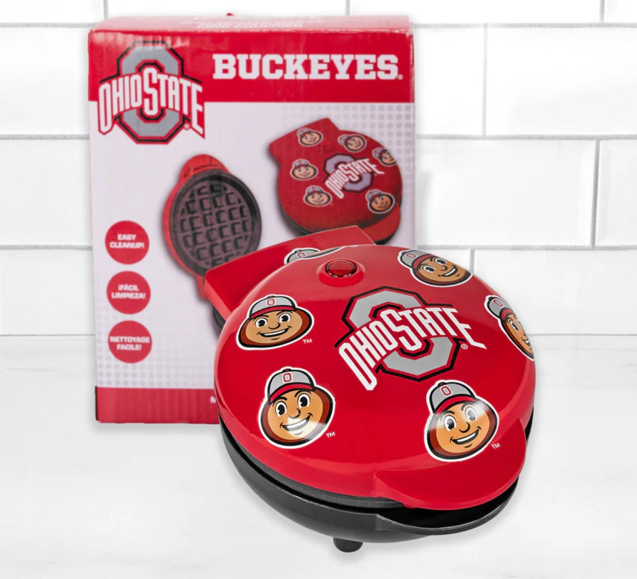 Red Ohio State waffle maker with packaging on a white tiled background
