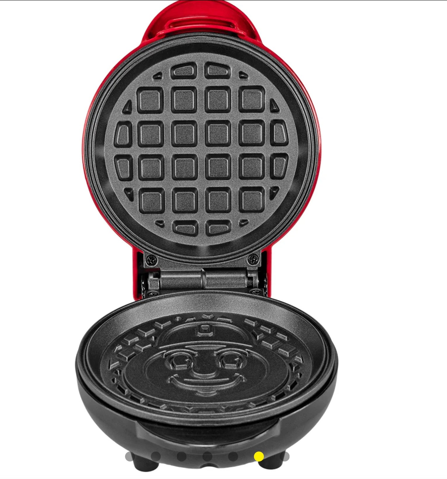 Red waffle maker with open lid showing grid pattern on a white background