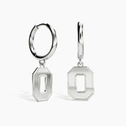 A pair of silver hoop earrings with hanging octagonal letter 'O' charms, shown on a clean white background.
