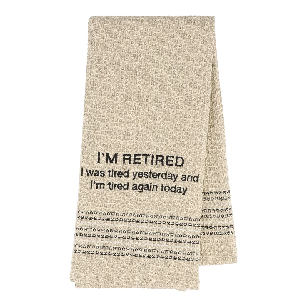 Beige towel with text 'I'M RETIRED I was tired yesterday and I'm tired again today' on a white background