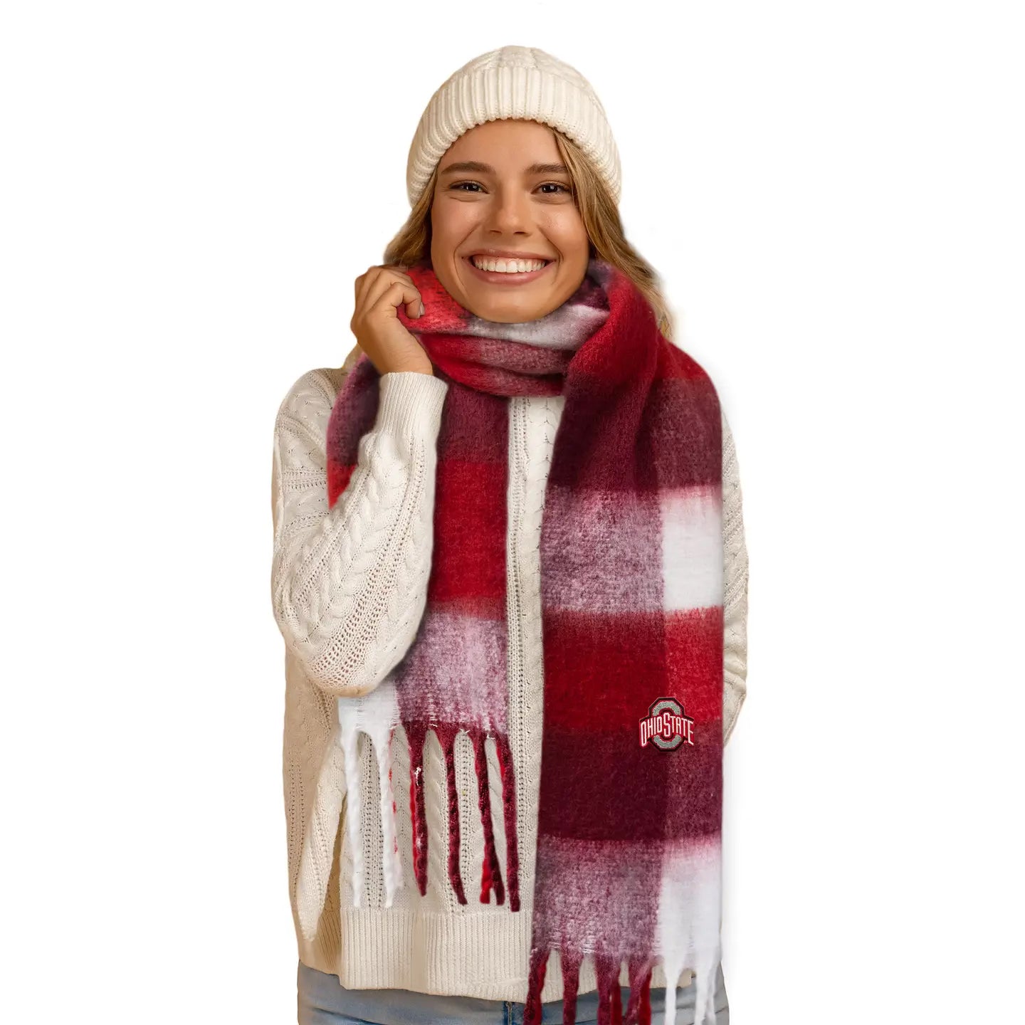 Person wearing a red and white plaid scarf with a logo, smiling on a white background