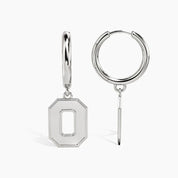 A pair of silver letter O hoop drop earrings, showing both the front view with a geometric octagonal pendant and the side profile with the hinged hoop and dangling bar.