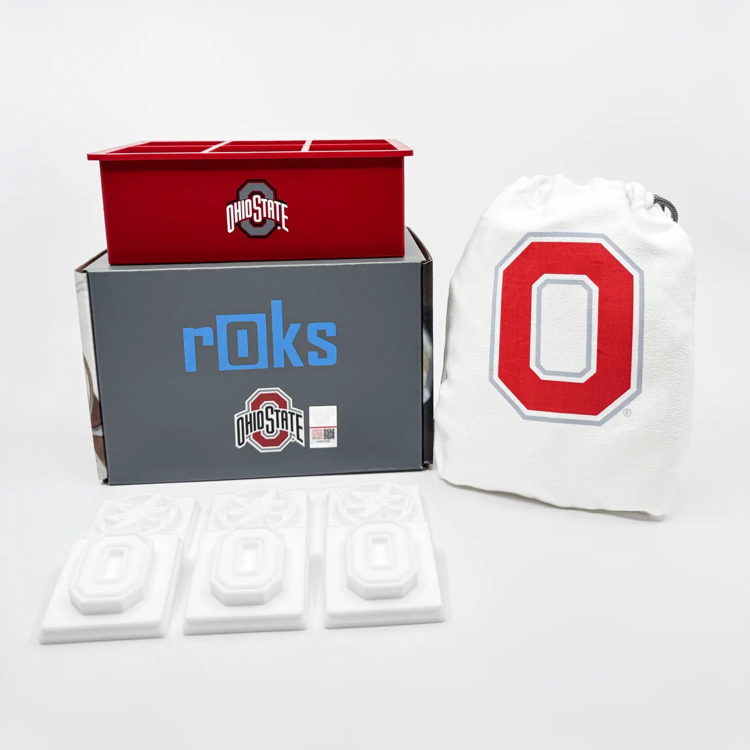 Ohio State-themed items including a red box, gray box, white bag with 'O', and small white objects on a light gray background.